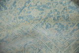 Worn pile of a distressed Mahal carpet, with subtle pale blue Herati pattern on arctic white ground.