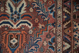 Vintage Baktiari carpet detail: floral palmettes, dragon-inspired border in sapphire blue, madder red.