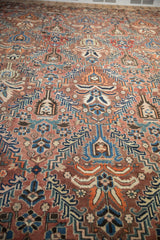 Persian Baktiari carpet with floral palmette design in madder red, sapphire blue, and chestnut.