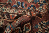 Folded vintage Baktiari rug, revealing madder root red floral palmettes and mostly even pile wear.