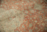 Detail of a scalloped ivory medallion on the distressed terracotta field of a vintage Kayseri.