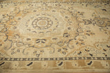 Angled view across the low, distressed pile of a vintage Kars rug with Rococo scrolls.