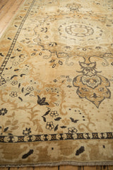 Angled perspective on the distressed pile, showing charcoal Rococo scrolls and floral motifs.