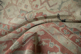 Folded view showing the supple texture and worn knot heads of the vintage Anatolian carpet.