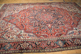 Curved linear medallion and contrasting ivory corner spandrels on a vintage Ahar carpet.