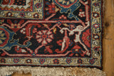 Corner detail of a vintage Persian Ahar rug showing its dense wool pile and secure fringe.