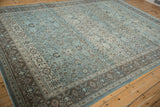 Vintage distressed Qom carpet, intricate blue scrolling florals and distinct patterned border.