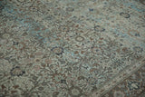 Distressed overdyed Qom carpet shows intricate floral patterns in aqua blue and brown.