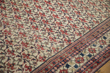 Vintage Baktiari carpet's allover red floral bat field motif and pomegranate leaf border.