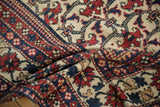 Intricate brick red, cobalt blue, and ivory floral patterns of the Baktiari rug.