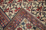 Hand-knotted Baktiari carpet corner detail with floral bat and pomegranate leaf border.