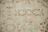 Distressed Vintage Meshed rug texture, showing faded floral motifs and visible foundation.