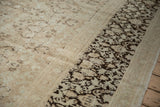 Distressed Meshed carpet detail: faded sandalwood field meets chocolate brown floral border.