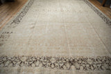 Distressed Meshed rug texture, with dark brown floral border and faded field patterns.
