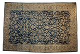 Distressed tea-washed Persian Lilihan carpet with an allover floral design in navy blue and sand tones with dynamic abrashes.