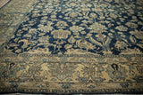 Angled close-up of worn knot heads and floral vinery on a distressed Persian Lilihan carpet.