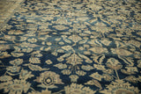 Angled view of bell-shaped arabesques and palmettes on a distressed vintage Lilihan carpet.