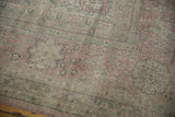 Distressed pile texture of vintage Sparta carpet with dusty rose and muted green floral patterns.
