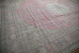 Distressed Sparta carpet border showing dusty rose field, faded palmettes and curvilinear motifs.