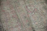 Faded dusty rose and oxidized silver palmettes on distressed Turkish Sparta carpet pile.