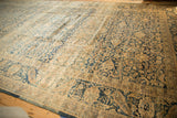 Distressed Meshed carpet detail, dusty gold and blue floral field with palmette border.