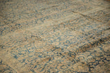 Decorative distressed texture of vintage Meshed carpet, with muted blue and sand palmettes.