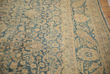 Distressed vintage Meshed carpet with faded blue floral field and sand palmette border.