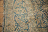 Vintage Meshed rug's distressed side, showing intact fringe and blue palmette border.