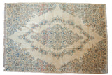 Vintage Kerman carpet with central medallion, thousand flower spandrels, ivory field, blue and apricot hues.