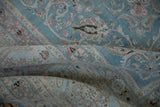 Distressed vintage Meshed carpet, highlighting heavy abrashes, pale blue, and dusty rose arabesque patterns.