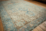 Abrashed pale blue and ivory geometric blossom patterns on a distressed Mehrivan rug.