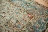 Distressed vintage Mehrivan rug detail with abrash, geometric motifs, pale blue and terracotta.