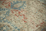 Distressed vintage Mehrivan carpet with geometric blossoms in pale denim blue and terracotta.
