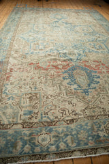 Distressed vintage Mehrivan rug border with faded blue, ivory, and subtle terracotta geometric motifs.