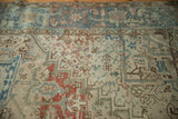 Vintage distressed Mehrivan carpet detail: geometric blossoms, pale blues, terracotta, and abrashed ivory ground.