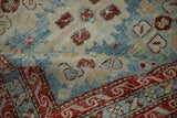 Supple, distressed texture of a folded antique Persian runner with geometric medallions.