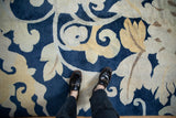 Oversized cobalt blue and saffron floral vines of a soft pile Tibetan carpet.