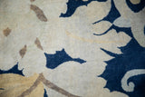 Sprawling cobalt blue palmettes and beige vines on this hand-knotted Tibetan carpet.