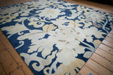 Oversized floral palmettes and curling vines in cobalt blue and pale saffron.