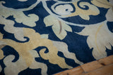 Vintage Tibetan carpet detail: sprawling cobalt blue, saffron yellow, beige floral palmettes.