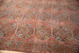 Distressed Ersari carpet detail revealing faded oversized guls and serrated leaf border.