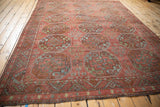 Distressed antique Ersari carpet's serrated leaf main border in dusty red, jade, and burnt orange.