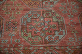 Distressed Ersari gul motif with serrated leaf border in faded red, sky blue, and jade green.