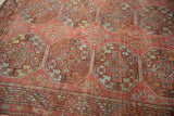 Antique distressed Ersari carpet detail: repeating guls, serrated border, dusty red, jade, sky blue.