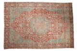 Distressed vintage Persian Khoy carpet with raspberry red, dusty teal medallion, 9' x 13'.
