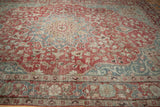 Distressed Khoy carpet showcasing raspberry red floral vines and ornate Samovar dragon border.
