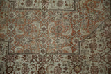 Intricate Herati design and cartouche border detail on a finely knotted antique Tabriz rug.