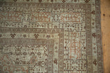 Signature cartouche main borders of a fine antique Tabriz carpet in sand, silver, and copper tones.