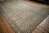 Signature cartouche border and allover Herati field of a fine antique Tabriz carpet shown at an angle.