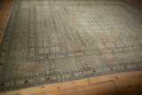 Signature cartouche border of an antique Tabriz carpet in sandalwood, beige, and muted copper tones.